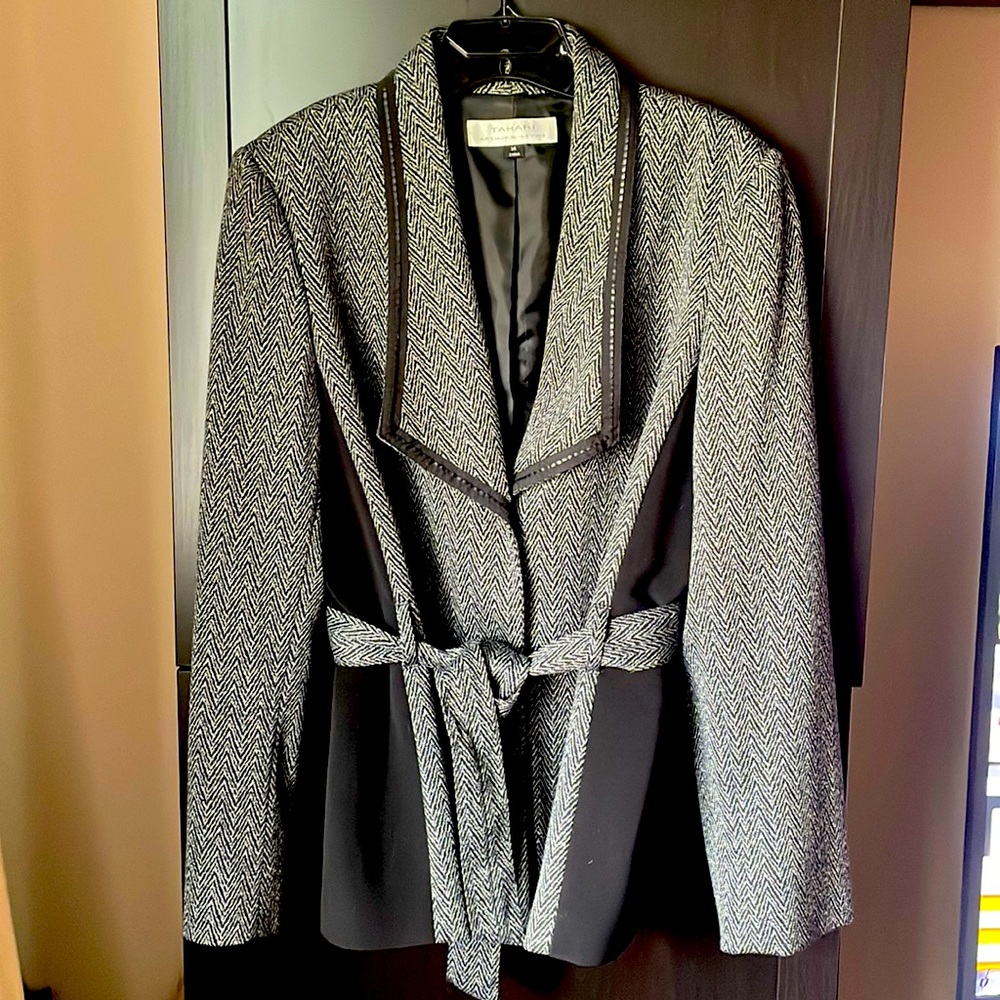 Gently worn Tahari blazer with detailed lapel collar and belt at waist.